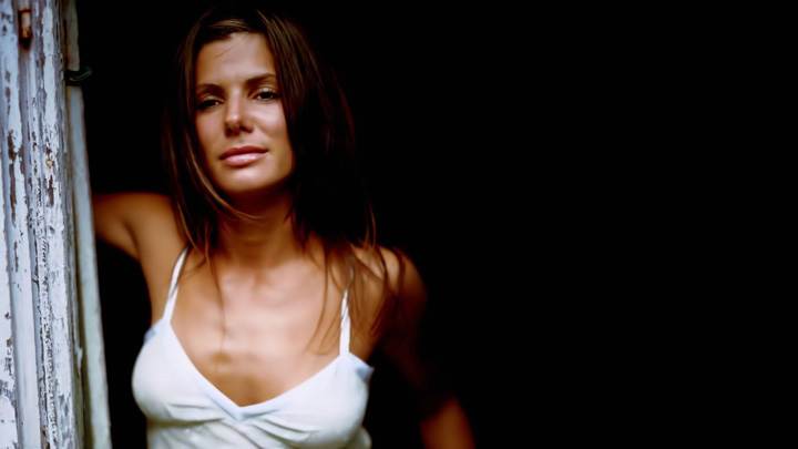 Sandra Bullock In White Top Looking Outside Door